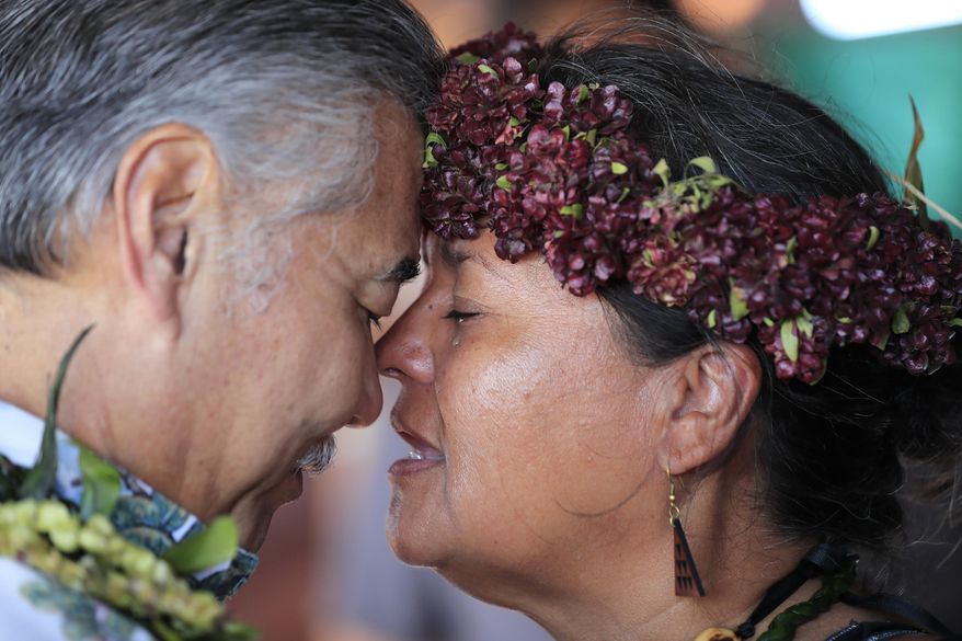 Hawaii governor David Ige, left, exchanges breath—or honi—with kupuna Napua McShane Burke during a visit to the ninth day of protests against the TMT telescope on Tuesday, July 23, 2019 at the base of Mauna Kea on Hawaii Island. The governor of Hawaii on Tuesday visited protesters blocking the construction of a giant telescope on the state's tallest mountain while acknowledging that their grievances were not just about a new observatory but also about the treatment of Native Hawaiians going back more than a century. (Jamm Aquino/Honolulu Star-Advertiser via AP)
