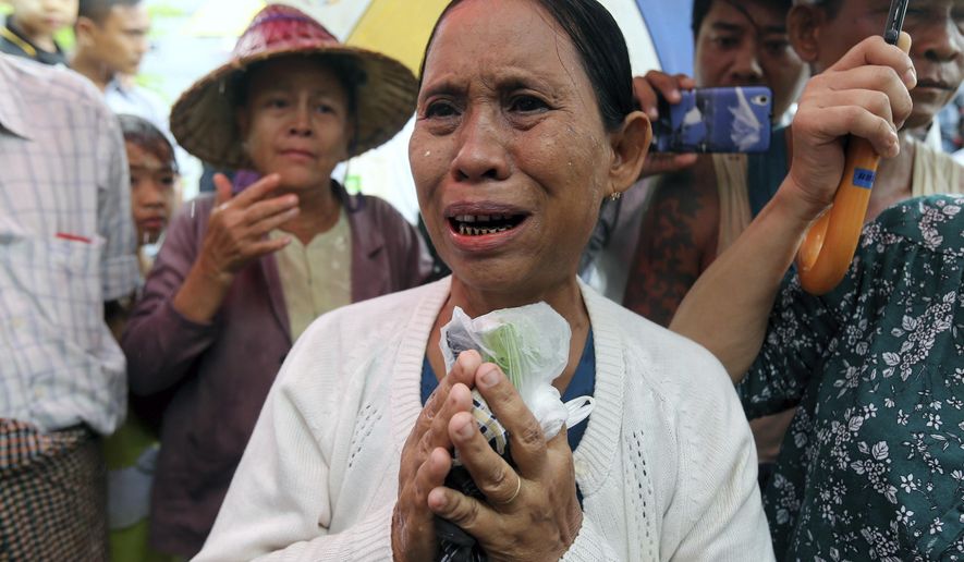 Daw Yee, mother of rape suspect Aung Kyaw Myo, talks to journalists after the trial of her son at a court Wednesday, July 24, 2019, in Nyapyitaw, Myanmar. A Myanmar court held another hearing related to the rape of a 2-year old girl at her nursery school, in a case that generated huge interest and protests. (AP Photo/Aung Shine Oo)