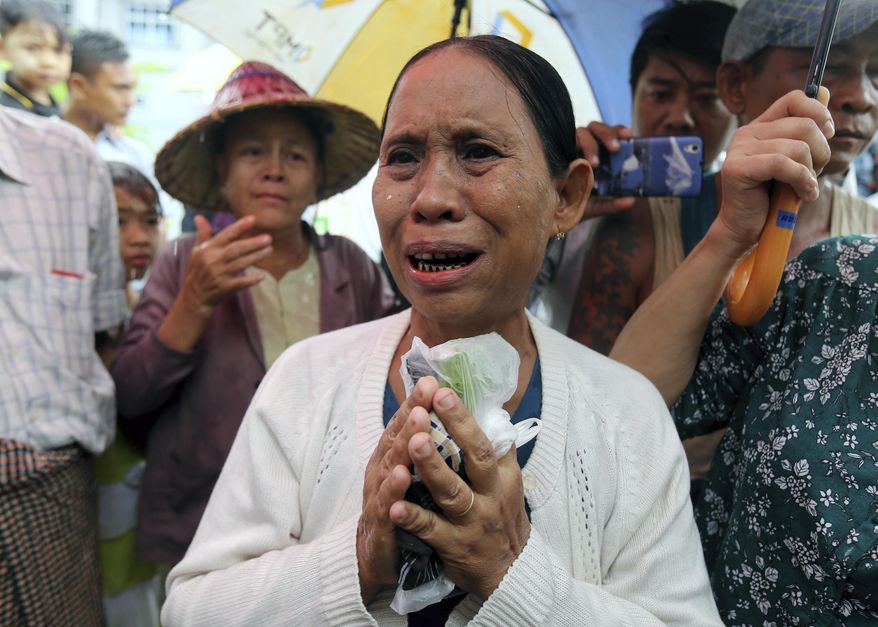 Daw Yee, mother of rape suspect Aung Kyaw Myo, talks to journalists after the trial of her son at a court Wednesday, July 24, 2019, in Nyapyitaw, Myanmar. A Myanmar court held another hearing related to the rape of a 2-year old girl at her nursery school, in a case that generated huge interest and protests. (AP Photo/Aung Shine Oo)