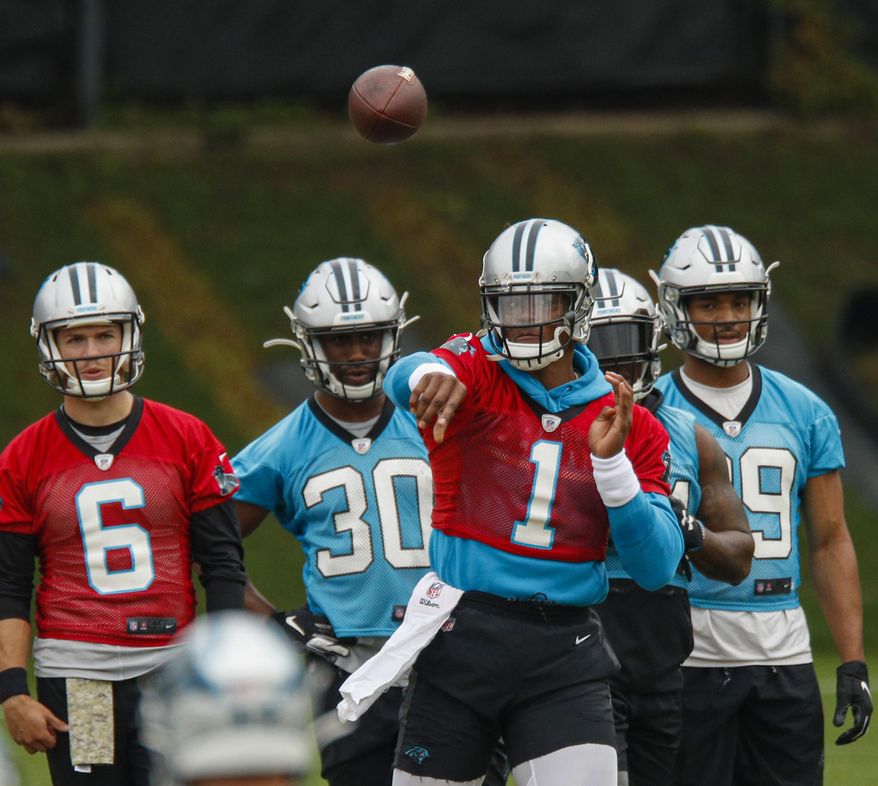 FILE - In this June 13, 2019, file photo, Carolina Panthers quarterback Cam Newton (1) throws a pass during the NFL football team's practice in Charlotte, N.C. While Cam Newton has been medically cleared to throw in training camp following shoulder surgery, Panthers coach Ron Rivera said the team’s training staff will closely monitor his reps. (AP Photo/Nell Redmond, File)