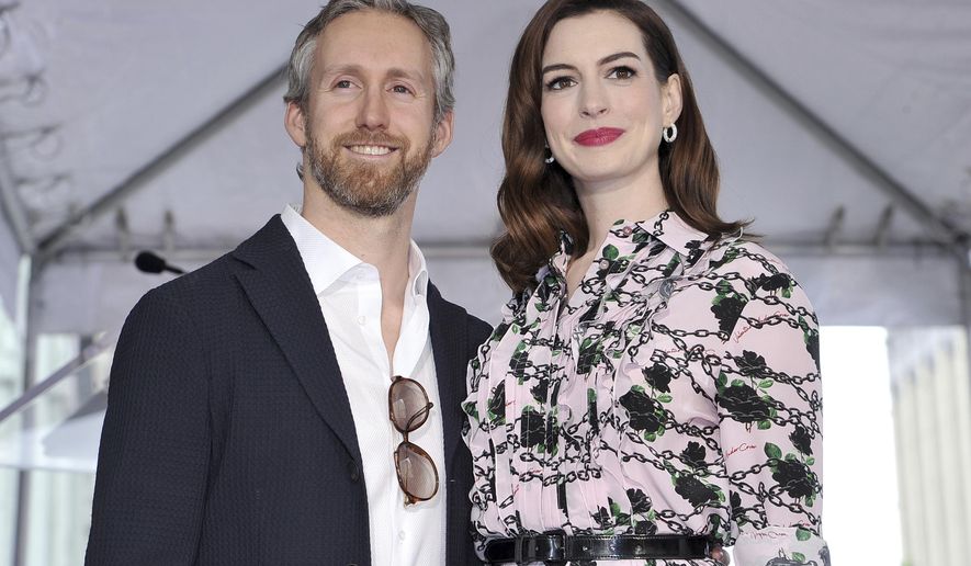 FILE - This May 9, 2019 file photo shows actress Anne Hathaway, right, and her husband Adam Shulman at a ceremony honoring Hathaway with a star on the Hollywood Walk of Fame in Los Angeles. Hathaway announced Wednesday, July 24, on her Instagram account that she and husband are expecting their second child. (Photo by Richard Shotwell/Invision/AP, File)