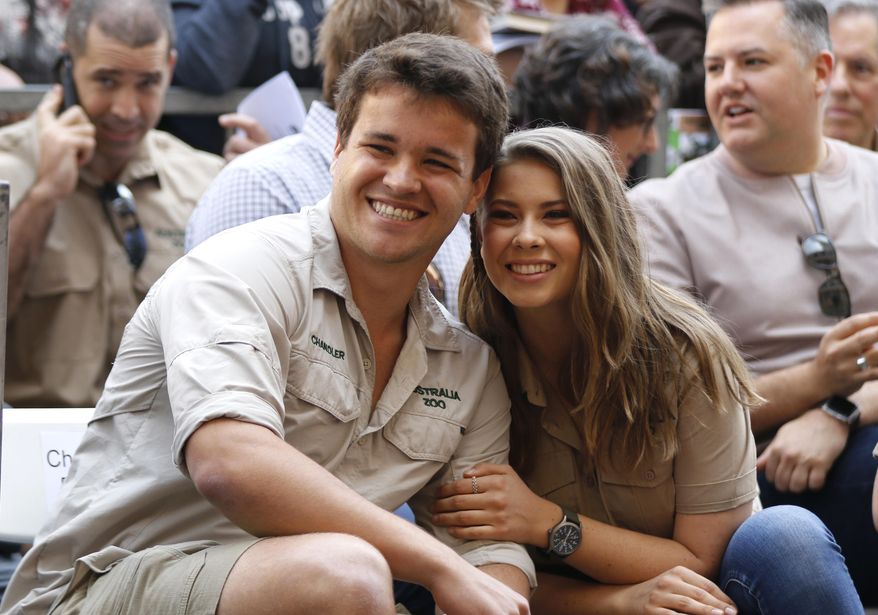 FILE - This April 26, 2018 file photo shows Chandler Powell, left, and Bindi Irwin at a ceremony honoring the late Steve Irwin with a star on the Hollywood Walk of Fame in Los Angeles. Irwin posted on her social media Wednesday, July 24, 2019 that Powell, her longtime boyfriend proposed on July 23, her 21st birthday. (Photo by Willy Sanjuan/Invision/AP, File)