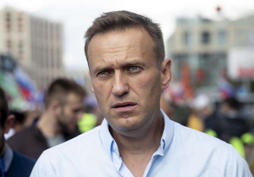 FILE In this file photo taken on Saturday, July 20, 2019, Russian opposition activist Alexei Navalny attends a protest in Moscow, Russia. Navalny has been detained by police near his home in Moscow as he left for a jog, it was reported on Wednesday, July 24, 2019. (AP Photo/Pavel Golovkin, File)