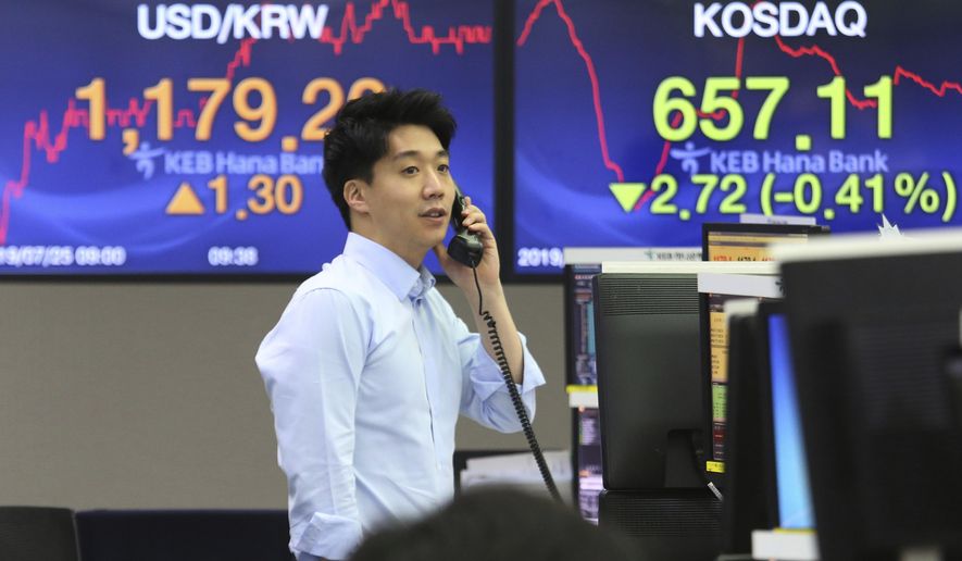 A currency trader talks on the phone at the foreign exchange dealing room of the KEB Hana Bank headquarters in Seoul, South Korea, Thursday, July 25, 2019. Asian shares have rallied after the S&P 500 and Nasdaq closed at record highs. South Korea’s Kospi sank early Thursday after North Korea launched two short range missiles into the sea.(AP Photo/Ahn Young-joon)