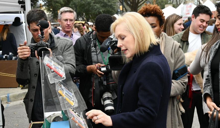 FILE - In this Feb. 9, 2019, file photo, Democratic presidential candidate Sen. Kirsten Gillibrand, D-N.Y., walks Columbia's Main Street farmers market ahead of a women's luncheon Reed hosted for her in Columbia, S.C. Tourism is nothing new to South Carolina, known for its historic towns, lush golf courses and gleaming beaches. Home of the first presidential primaries in the South, the state becomes a destination for onlookers eager to catch a glimpse of the political spectacle. (AP Photo/Meg Kinnard, File)