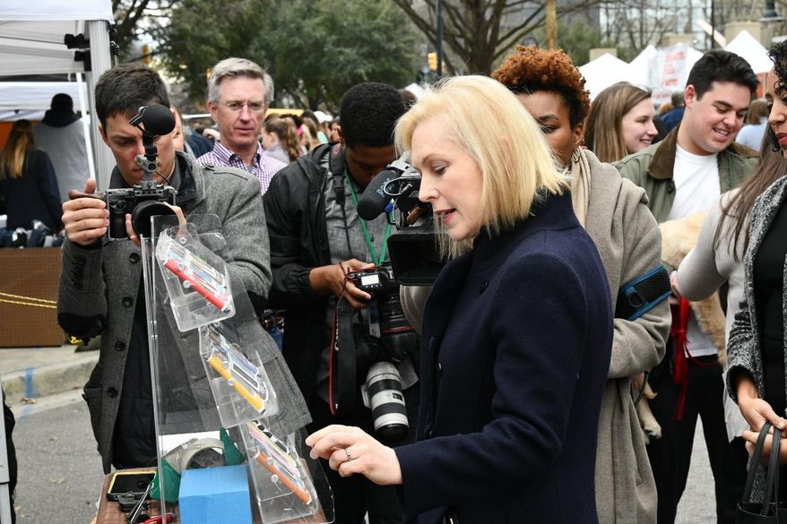 FILE - In this Feb. 9, 2019, file photo, Democratic presidential candidate Sen. Kirsten Gillibrand, D-N.Y., walks Columbia's Main Street farmers market ahead of a women's luncheon Reed hosted for her in Columbia, S.C. Tourism is nothing new to South Carolina, known for its historic towns, lush golf courses and gleaming beaches. Home of the first presidential primaries in the South, the state becomes a destination for onlookers eager to catch a glimpse of the political spectacle. (AP Photo/Meg Kinnard, File)