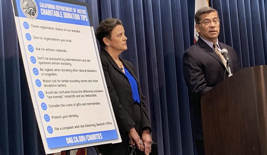 California Attorney General Xavier Becerra, right, and senior Assistant Attorney Genera Tania Ibanez announce a lawsuit the state has filed alleging misdeeds by Move America Forward, a nonprofit that sends packages of food, clothes or other items to military service personnel, at a Los Angeles news conference Wednesday, July 24, 2019. (AP Photo/Natalie Rice)
