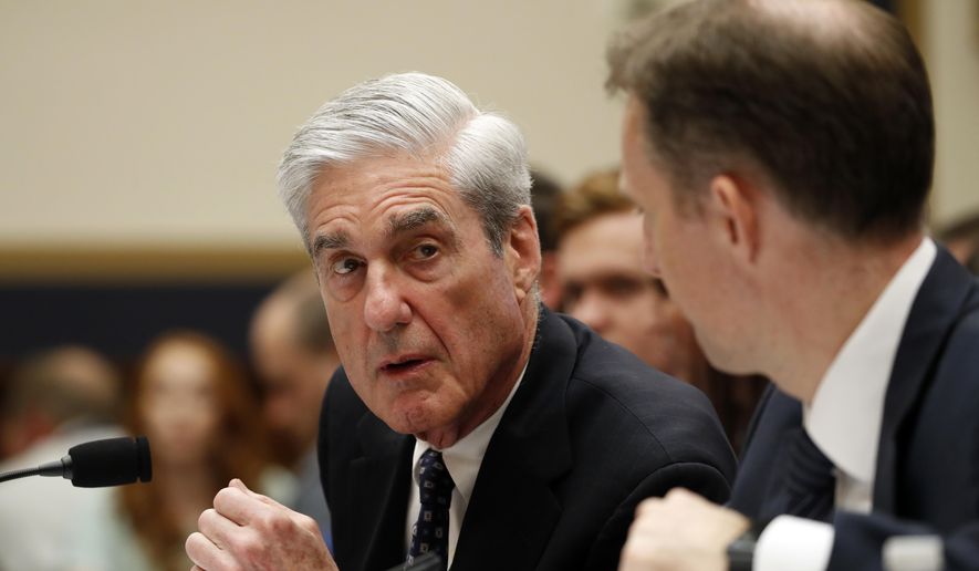 Former special counsel Robert Mueller, accompanied by his top aide in the investigation Aaron Zebley, right, testifies before the House Intelligence Committee hearing on his report on Russian election interference, on Capitol Hill, Wednesday, July 24, 2019 in Washington. (AP Photo/Alex Brandon)