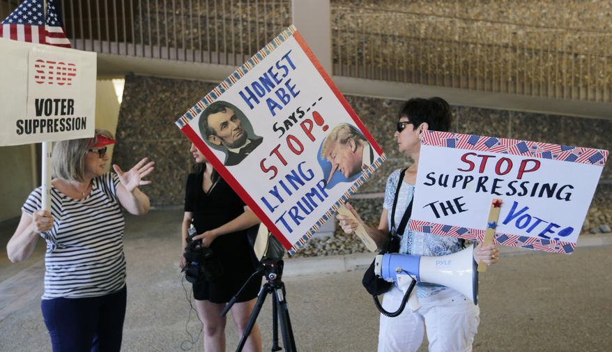 FILE - In this July 10, 2017, file photo, protesters gather outside the federal courthouse in San Antonio, where a redistricting trial was taking place. Putting aside "grave concerns" over Texas' record on voting rights in recent years, a federal court Wednesday, July 24, 2019, said the state doesn't need federal supervision to change voting laws in a key ruling ahead of the 2020 Census. (AP Photo/Eric Gay, File)