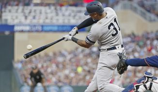 New York Yankees&#x27; Aaron Hicks hits an RBI single off Minnesota Twins pitcher Jake Odorizzi in the fourth inning of a baseball game Wednesday, July 24, 2019, in Minneapolis. (AP Photo/Jim Mone)