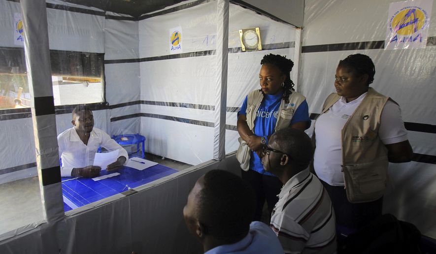 In this Saturday, July 20, 2019, photo, Claude Mabowa Sasi, 21, who had lost his mother, a brother and a sister to Ebola, takes his college-entry exam in an isolation room at an Ebola treatment center in Beni, Congo. (AP Photo/Al-Hadji Kudra Maliro)