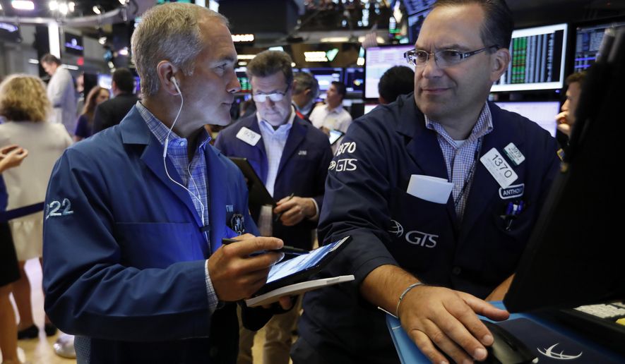 FILE - In this Friday, July 19 2019, file photo trader Timothy Nick, left, and specialist Anthony Matesic work on the floor of the New York Stock Exchange. The U.S. stock market opens at 9:30 a.m. EDT on Thursday, July 25. (AP Photo/Richard Drew, File)