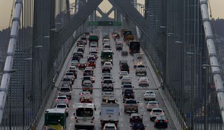 In this Dec. 10, 2015, file photo, vehicles make their way westbound on Interstate 80 across the San Francisco-Oakland Bay Bridge as seen from Treasure Island in San Francisco. (AP Photo/Ben Margot, File)