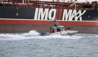 In this Sunday, July 21, 2019 photo, a speedboat of the Iran&#39;s Revolutionary Guard moves around a British-flagged oil tanker Stena Impero which was seized in the Strait of Hormuz on Friday by the Guard, in the Iranian port of Bandar Abbas. Global stock markets were subdued Monday while the price of oil climbed as tensions in the Persian Gulf escalated after Iran&#39;s seizure of a British oil tanker on Friday. (Morteza Akhoondi/Mehr News Agency via AP)