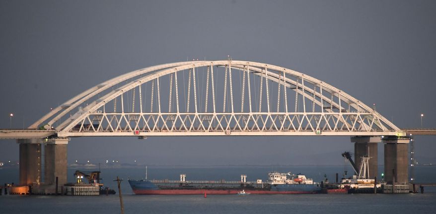 FILE - In this file photo taken on Sunday, Nov. 25, 2018, a Russian tanker under the the Kerch bridge blocks the passage to the Kerch Strait near Kerch, Crimea. The Ukrainian Security Service (SBU) said in a statement Thursday July 25, 2019, that it has seized the Russian tanker moored in a Ukrainian Black Sea port. (AP Photo)