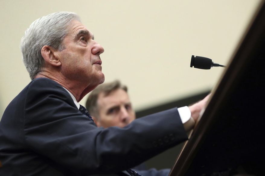 Former special counsel Robert Mueller, accompanied by his top aide in the investigation Aaron Zebley, testifies before the House Intelligence Committee hearing on his report on Russian election interference, on Capitol Hill, in Washington, Wednesday, July 24, 2019. (AP Photo/Andrew Harnik)