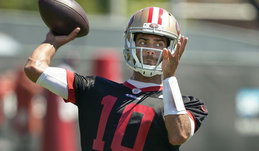 FILE - In this Tuesday, June 10, 2019 file photo, San Francisco 49ers quarterback Jimmy Garoppolo throws a pass during a drill at the team's NFL football training facility in Santa Clara, Calif. Quarterback Jimmy Garoppolo has been cleared for everything when training camp begins for the San Francisco 49ers. Garoppolo passed his final test Friday, July 26, 2019 in his return from season-ending knee surgery when he took his physical when the Niners arrived at training camp. Garoppolo was limited to seven-on-seven drills during the offseason to avoid any possible contact to protect his left knee but will be able to take part in full team drills when practice starts on Saturday. (AP Photo/Tony Avelar, File)