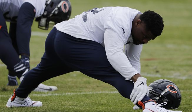 Chicago Bears linebacker Khalil Mack stretches during an NFL football training camp in Bourbonnais, Ill., Friday, July 26, 2019. (AP Photo/Nam Y. Huh)