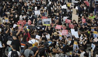 Demonstrators gather during a protest at Hong Kong International Airport, Friday, July 26, 2019. Hong Kong residents have been protesting for more than a month to call for democratic reforms and the withdrawal of a controversial extradition bill. Their five central demands include direct elections, the dissolution of the current legislature, and an investigation into alleged police brutality. Clashes between protesters and police and other parties have become increasingly violent. (AP Photo/Vincent Yu)