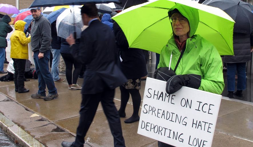 FILE - In this Feb. 4, 2019 file photo, supporters of immigrant Sujitno Sajuti rally outside the federal courthouse in Hartford, Conn. Immigration officials say Sajuti, 70, who came to the U.S. in 1981 and overstayed a student visa, is evading immigration law. A sweeping expansion of deportation powers unveiled this week by the Trump administration has sent chills through immigrant communities and prompted some lawyers to advise migrants to gather up as much documentation as possible, pay stubs, apartment leases or even gym key tags, to prove they’ve been in the U.S.(AP Photo/Dave Collins)