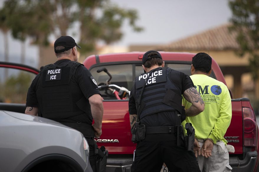 In this July 8, 2019, photo, a U.S. Immigration and Customs Enforcement (ICE) officers detain a man during an operation in Escondido, Calif.  A sweeping expansion of deportation powers unveiled this week by the Trump administration has sent chills through immigrant communities and prompted some lawyers to advise migrants to gather up as much documentation as possible _ pay stubs, apartment leases or even gym key tags _ to prove they’ve been in the U.S. (AP Photo/Gregory Bull)