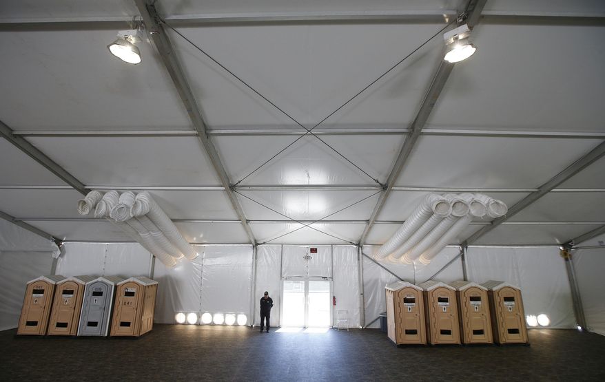 FILE - This June 28, 2019 file photo shows part of a new 500-person tent facility during a media tour by the U.S. Border Patrol in Yuma, Ariz. It will be used to process detained immigrant children and families who cross the U.S. border. On Friday, July 26, 2019, The Associated Press reported on stories circulating online incorrectly asserting that detained migrants are free to leave detention centers at any time to go back to Mexico. (AP Photo/Ross D. Franklin)