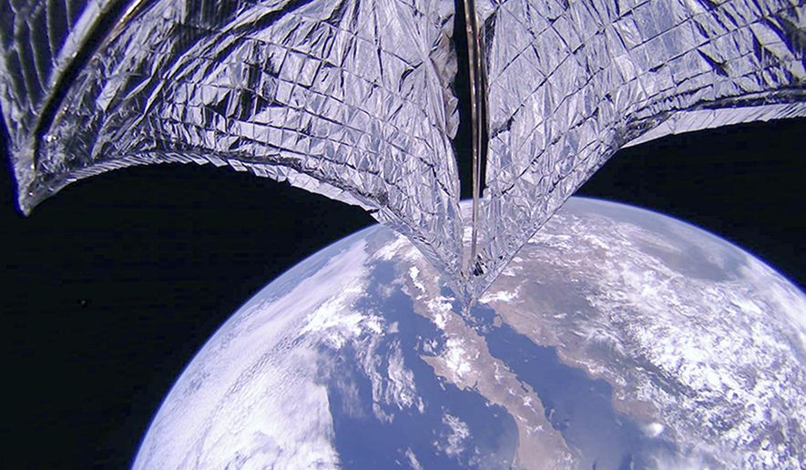 This photo provided on Thursday, July 25, 2019, by the Planetary Society shows a portion of the LightSail2 spacecraft, top, and part of Earth, centered on Baja California, Mexico. It was one of the photos transmitted from The Planetary Society's LightSail 2 spacecraft, confirming the successful deployment of its solar sail. (Planetary Society via AP)