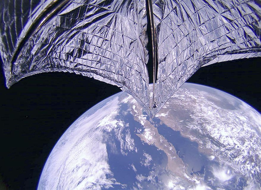 This photo provided on Thursday, July 25, 2019, by the Planetary Society shows a portion of the LightSail2 spacecraft, top, and part of Earth, centered on Baja California, Mexico. It was one of the photos transmitted from The Planetary Society's LightSail 2 spacecraft, confirming the successful deployment of its solar sail. (Planetary Society via AP)