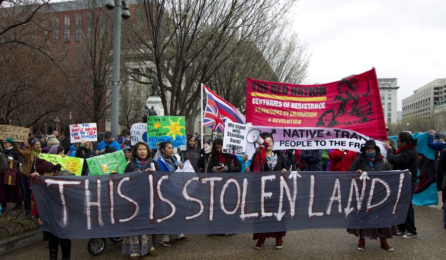 FILE - In this March 10, 2017, file photo, America Indians and their supporters protest outside of the White House in Washington, to rally against the construction of the disputed Dakota Access oil pipeline. The American Indian tribe at the center of tumultuous protests against the Dakota Access pipeline is showing off its solar farm that backers are billing as the largest in North Dakota. The Standing Rock Sioux Tribe's solar project is meant as a first step toward clean energy independence and a way to power all 12 of the reservation communities. The grand opening is Friday night, July 26, 2019. (AP Photo/Jose Luis Magana, File)