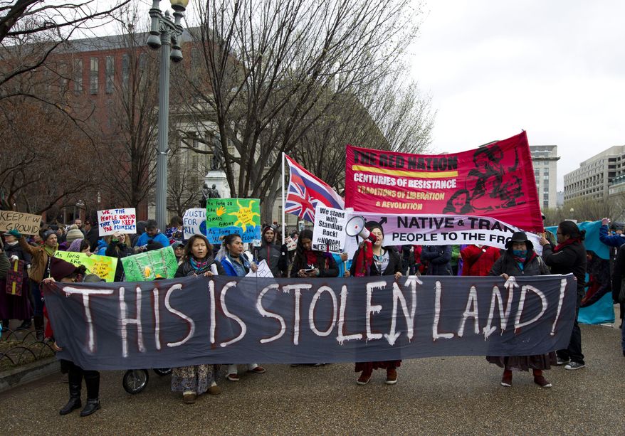 FILE - In this March 10, 2017, file photo, America Indians and their supporters protest outside of the White House in Washington, to rally against the construction of the disputed Dakota Access oil pipeline. The American Indian tribe at the center of tumultuous protests against the Dakota Access pipeline is showing off its solar farm that backers are billing as the largest in North Dakota. The Standing Rock Sioux Tribe's solar project is meant as a first step toward clean energy independence and a way to power all 12 of the reservation communities. The grand opening is Friday night, July 26, 2019. (AP Photo/Jose Luis Magana, File)
