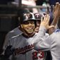 Minnesota Twins&#39; Nelson Cruz celebrates with teammates in the dugout after hitting a solo home run during seventh inning of a baseball game against the Chicago White Sox, Friday, July 26, 2019, in Chicago. (AP Photo/Jeff Haynes)