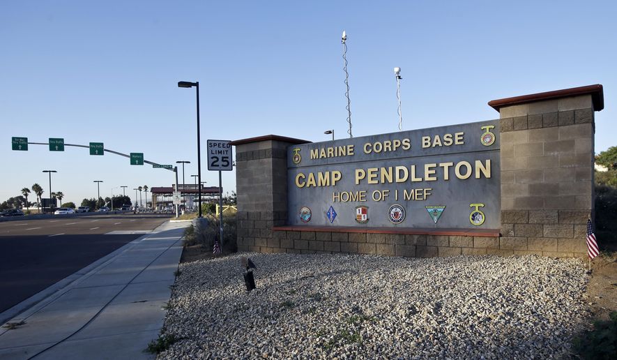 This Nov. 13, 2013, photo shows the main gate of Camp Pendleton Marine Base at Camp Pendleton, Calif. An active-duty Marine stationed at Pendelton was arrested on Feb. 8, 2022, on charges of cyberstalking multiple young women in California as part of a “sextortion” campaign. (AP Photo/Lenny Ignelzi) **FILE**