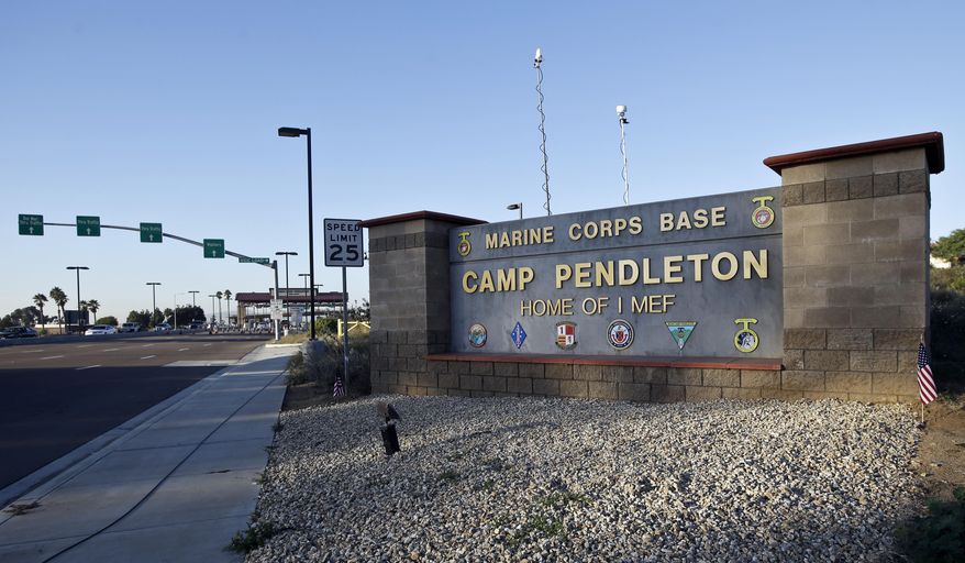 This Nov. 13, 2013, photo shows the main gate of Camp Pendleton Marine Base at Camp Pendleton, Calif. An active-duty Marine stationed at Pendelton was arrested on Feb. 8, 2022, on charges of cyberstalking multiple young women in California as part of a “sextortion” campaign. (AP Photo/Lenny Ignelzi) **FILE**