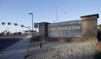 This Nov. 13, 2013, photo shows the main gate of Camp Pendleton Marine Base at Camp Pendleton, Calif. A human smuggling investigation by the military led to the arrest of 16 Marines Thursday, July 25, 2019, while carrying out a battalion formation at California&#39;s Camp Pendleton, a base about an hour&#39;s drive from the U.S.-Mexico border. (AP Photo/Lenny Ignelzi) **FILE**