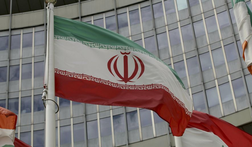 The Iranian flag waves outside of the UN building that hosts the International Atomic Energy Agency, IAEA, office inside in Vienna, Austria, Wednesday, July 10, 2019. President Donald Trump’s “maximum pressure” campaign against Iran is at a crossroads. His administration is trying to decide whether to risk stoking international tensions even more by ending one of the last remaining components of the 2015 nuclear deal. (AP Photo/Ronald Zak) **FILE**