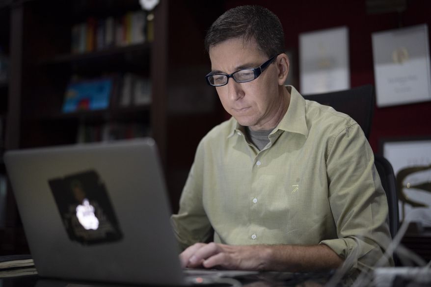 In this July 10, 2019, file photo, U.S. journalist Glenn Greenwald checks his news website at his home in Rio de Janeiro, Brazil. Greenwald, an attorney-turned-journalist who has long been a free-speech advocate, has found himself at the center of the first major test of press freedom under Brazil&#39;s President Jair Bolsonaro, who took office on Jan. 1 and has openly expressed nostalgia for Brazils 1964-1985 military dictatorship, a period when newspapers were censored and some journalists tortured. (AP Photo/Leo Correa) ** FILE **