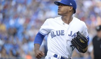 Toronto Blue Jays starting pitcher Marcus Stroman (6) looks back as a teammate makes a catch for an out against the Cleveland Indians during the first inning of a baseball game, Wednesday, July 24, 2019 in Toronto. (Nathan Denette/Canadian Press via AP)