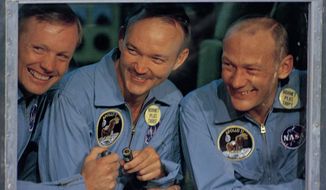 In this July 24, 1969, file photo, Apollo 11 astronauts, Neil Armstrong, left, Michael Collins, center, and Edwin &quot;Buzz&quot; Aldrin smile as they answer questions from quarantine in an isolation unit aboard the USS Hornet after splashdown and recovery. On April 28, 2021, a family spokesman announced that Michael Collins had died after a battle with cancer. He was 90. (AP Photo, File)