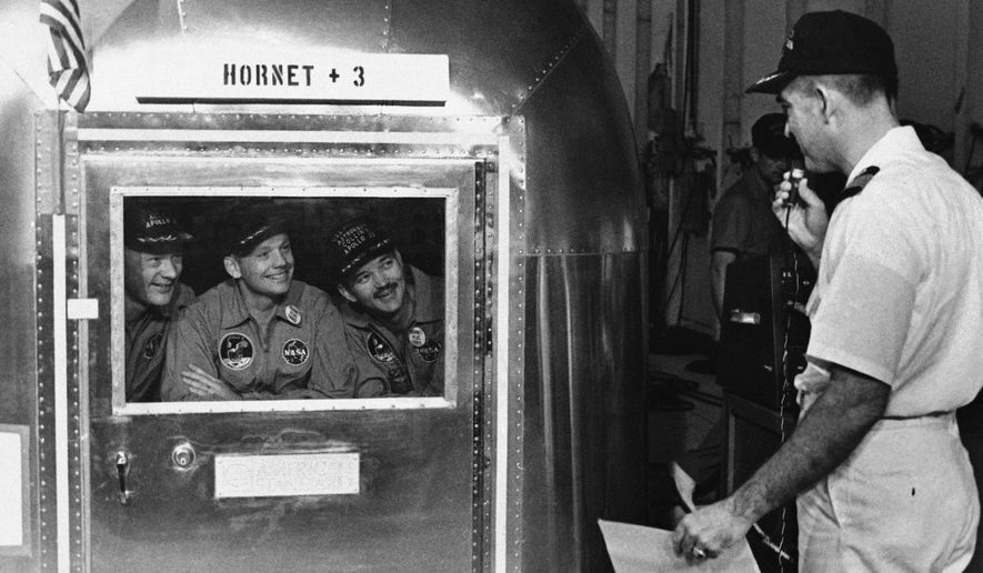 FILE - In this July 25, 1969, file photo, Capt. Carl Seiberlich, commander of the carrier Hornet, right, says goodbye to Apollo 11 astronauts Edwin Aldrin Jr., from left, Neil Armstrong and Michael Collins in Honolulu, Hawaii, before they were taken in their quarantine van to a waiting cargo plane to be flown to Houston, Texas. This week marked the 50th anniversary of the moon landing, but after those historic first steps NASA still had to get the three astronauts safely back to Earth, and the waters off Hawaii are where the cone-shaped spacecraft splashed down. (AP Photo, File)