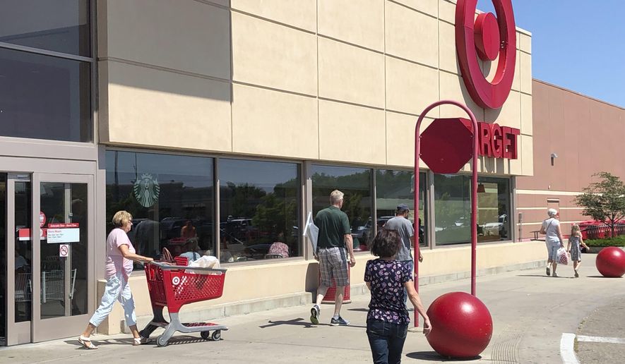 ADVANCE FOR MONDAY, JULY 29 - Shoppers enter and leave a Target store in Bismarck, North Dakota on Thursday, July 25, 2019. Beginning next month, North Dakotans for the first time since statehood will be able to shop on Sunday mornings. The changes are among hundreds of new state laws that take effect Aug. 1, representing the work of the 2019 Legislature. (AP Photo/James MacPherson)