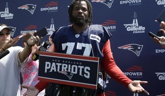 New England Patriots defensive lineman Michael Bennett faces reporters following practice at NFL football training camp, Sunday, July 28, 2019, in Foxborough, Mass. (AP Photo/Steven Senne)