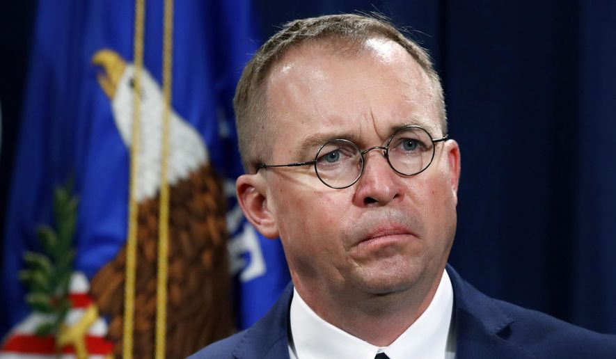 In this July 11, 2018, file photo, Mick Mulvaney listens during a news conference at the Department of Justice in Washington. (AP Photo/Jacquelyn Martin, File)