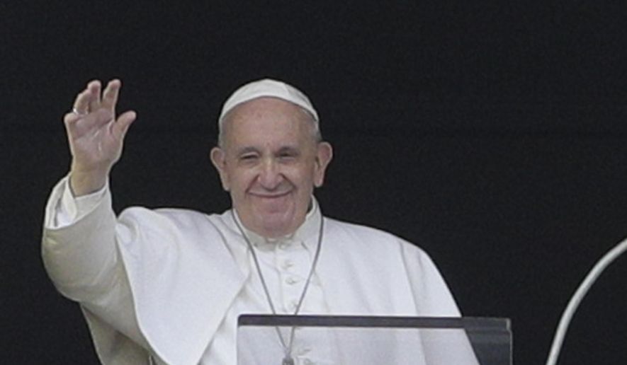 Pope Francis salutes from the window of his studio overlooking St. Peter's square at the Vatican, Sunday, July 28, 2019. Francis on Sunday bowed his head in silent prayer for the migrants, perhaps as many as 150, who perished last week in shipwrecks of smuggler’s boats near the Libyan coast. He invited faithful in St. Peter’s Square to join him in praying for the victims and their families. (AP Photo/Andrew Medichini)