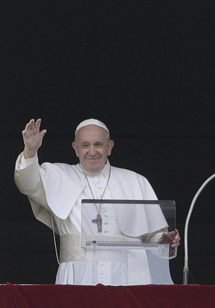 Pope Francis salutes from the window of his studio overlooking St. Peter's square at the Vatican, Sunday, July 28, 2019. Francis on Sunday bowed his head in silent prayer for the migrants, perhaps as many as 150, who perished last week in shipwrecks of smuggler’s boats near the Libyan coast. He invited faithful in St. Peter’s Square to join him in praying for the victims and their families. (AP Photo/Andrew Medichini)