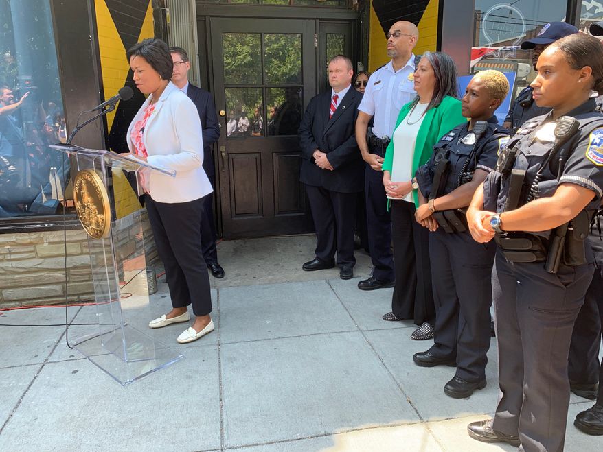 D.C. Mayor Muriel Bowser urges residents, businesses and nonprofit groups to participate in the city's Private Security Camera System Incentive Program outside of Jackie Lee's bar in Northwest on Monday. The bar was the site of a drive-by shooting on New Year's Eve. The program aims to reduce crime and catch criminals using surveillance cameras in neighborhoods. (Ximena Bustillo/ The Washington Times)