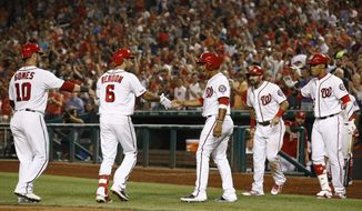 Washington Nationals&#39; Anthony Rendon (6) celebrates his grand slam with teammates, from left to right, Yan Gomes, Adrian Sanchez, Adam Eaton and Juan Soto in the sixth inning of a baseball game against the Atlanta Braves, Monday, July 29, 2019, in Washington. (AP Photo/Patrick Semansky)