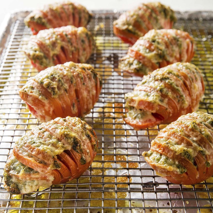 This undated photo provided by America's Test Kitchen in July 2019 shows Hasselback Tomatoes in Brookline, Mass. This recipe appears in the cookbook "New Essentials." (Joe Keller/America's Test Kitchen via AP)