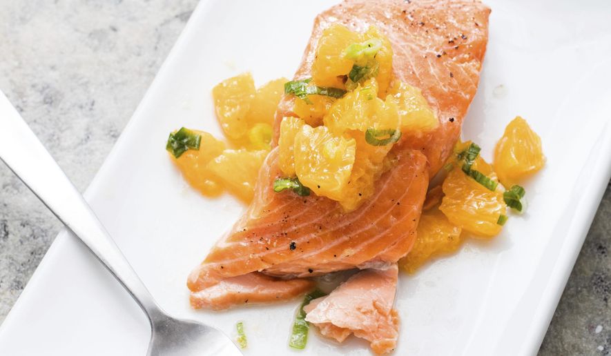 This undated photo provided by America's Test Kitchen in July 2019 shows Oven-Roasted Salmon with Relish in Brookline, Mass. This recipe appears in the cookbook “Nutritious Delicious.” (Daniel J. van Ackere/America's Test Kitchen via AP)