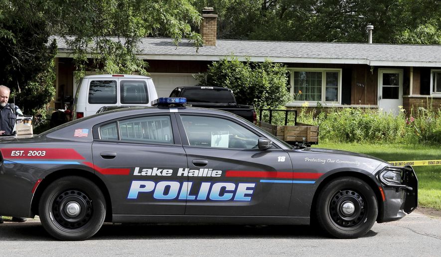 Lake Hallie Police work outside a home Monday, July 29, 2019, in Lake Hallie, Wis., following a shooting the night before. Authorities in northwestern Wisconsin say shootings at two homes have left five people dead, including the suspected shooter, and two others injured. (Dan Reiland/The Eau Claire Leader-Telegram via AP)