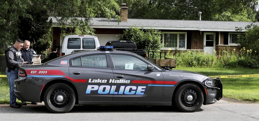 Lake Hallie Police work outside a home Monday, July 29, 2019, in Lake Hallie, Wis., following a shooting the night before. Authorities in northwestern Wisconsin say shootings at two homes have left five people dead, including the suspected shooter, and two others injured. (Dan Reiland/The Eau Claire Leader-Telegram via AP)